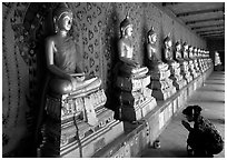 Woman worships a buddha image, Wat Arun. Bangkok, Thailand ( black and white)