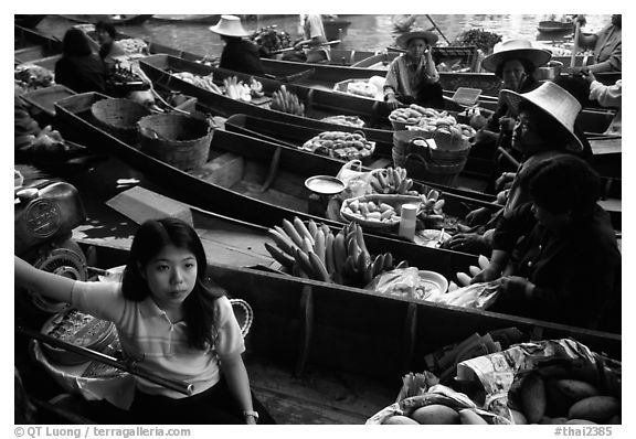 Woman on small boat, floating market. Damnoen Saduak, Thailand (black and white)