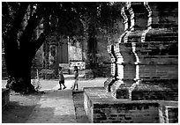 Children walk among ruins of the King Narai's palace. Lopburi, Thailand ( black and white)