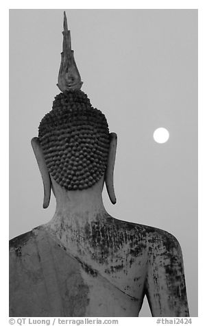 Moon and buddha image at dusk, Wat Mahathat. Sukothai, Thailand (black and white)