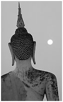 Moon and buddha image at dusk, Wat Mahathat. Sukothai, Thailand (black and white)