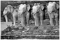 Some of the 36 elephants at the base of Wat Cahang Lom. Sukothai, Thailand ( black and white)