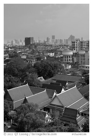 Temple rooftop and modern skyline. Bangkok, Thailand
