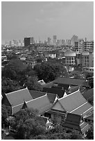 Temple rooftop and modern skyline. Bangkok, Thailand ( black and white)