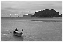Man driving long tail boat, Ao Nammao. Krabi Province, Thailand ( black and white)