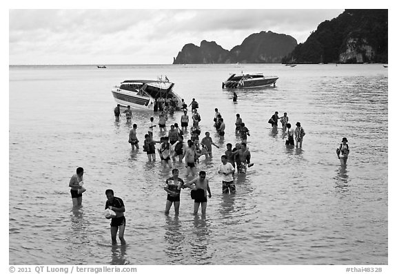 Asian tourists wading in water, Ko Phi Phi. Krabi Province, Thailand