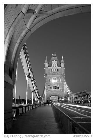 Walkway and road traffic on the Tower Bridge at night. London, England, United Kingdom