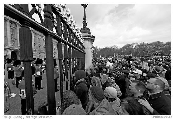 Crowds at the grids in front of Buckingham Palace watching the changing of the guard. London, England, United Kingdom (black and white)