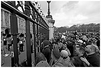 Crowds at the grids in front of Buckingham Palace watching the changing of the guard. London, England, United Kingdom (black and white)