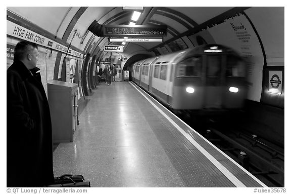 Man waiting for approaching train at Hyde Park subway station. London, England, United Kingdom (black and white)