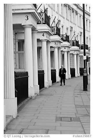 Businessman walking down near townhouses crescent. London, England, United Kingdom