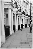 Businessman walking down near townhouses crescent. London, England, United Kingdom (black and white)