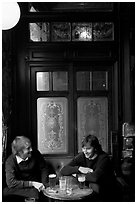 Young men, beer pints, and etched glass, pub Princess Louise. London, England, United Kingdom (black and white)