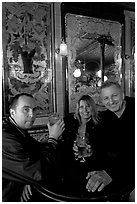 Friends cheering up with a beer in front of echted glass and fine tiles of pub Princess Louise. London, England, United Kingdom ( black and white)