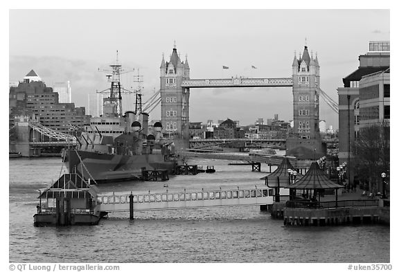 Historic boats, quays along the Thames, and Tower Bridge, late afternoon. London, England, United Kingdom (black and white)