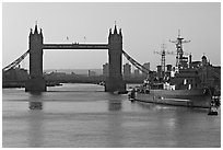 London Bridge, River Thames, and cruiser HMS Belfast at sunrise. London, England, United Kingdom (black and white)