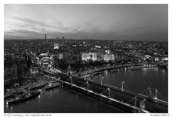 Aerial view of Charing Cross Station, Hungerford Bridge and Golden Jubilee Bridges at sunset. London, England, United Kingdom (black and white)
