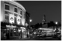 Tavern, moving double decker bus, and church at night. Greenwich, London, England, United Kingdom ( black and white)