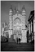 West facade of Bath Abbey with couple silhouette, late afternoon. Bath, Somerset, England, United Kingdom (black and white)