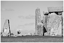 Couple looking at the standing stones, Stonehenge, Salisbury. England, United Kingdom (black and white)