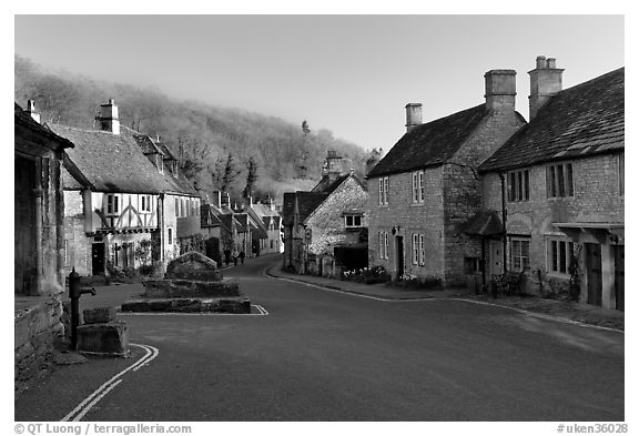 Main village street,  half timbered Court House, and Butter Cross, Castle Combe. Wiltshire, England, United Kingdom (black and white)