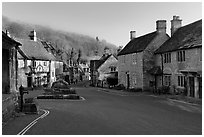 Main village street,  half timbered Court House, and Butter Cross, Castle Combe. Wiltshire, England, United Kingdom (black and white)