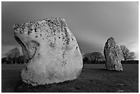 Large standing stones and brewing storm at dusk, Avebury, Wiltshire. England, United Kingdom (black and white)