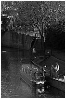 Family stepping out of houseboat onto quay. Bath, Somerset, England, United Kingdom (black and white)