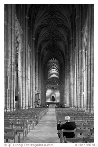 Man sitting in the Nave of the Canterbury Cathedral. Canterbury,  Kent, England, United Kingdom (black and white)