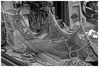 Woman repairing net on fishing boat. Whittier, Alaska, USA ( black and white)