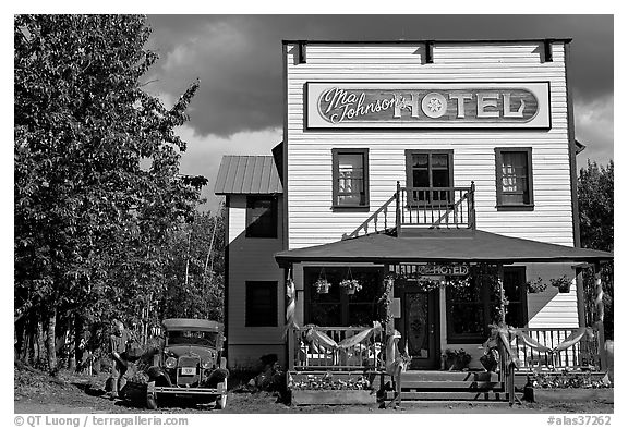 Small hotel with classic car parked by, afternoon. McCarthy, Alaska, USA