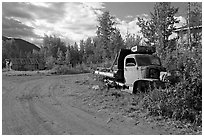 Side street with wrecked truck. McCarthy, Alaska, USA (black and white)
