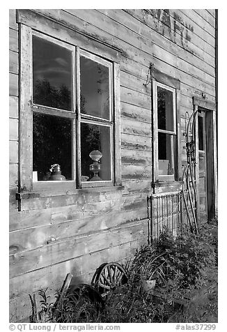 Windows and doors of old wooden building. McCarthy, Alaska, USA (black and white)