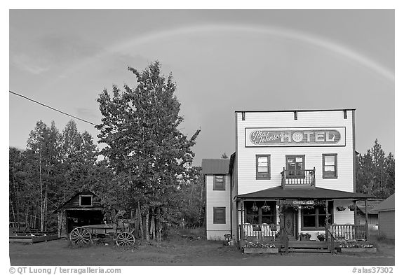Rainbow over the historic Ma Johnson hotel building. McCarthy, Alaska, USA (black and white)