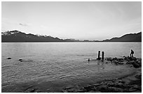 Boy standing in front of Resurrection Bay, sunset. Seward, Alaska, USA ( black and white)