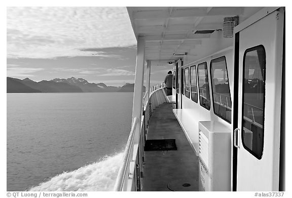 Passenger standing outside tour boat. Seward, Alaska, USA (black and white)