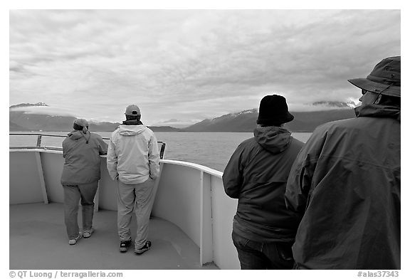 Passengers standing on deck with colorful  clothes. Seward, Alaska, USA
