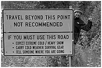 Sign with warnings about winter travel, Exit Glacier Road. Seward, Alaska, USA (black and white)