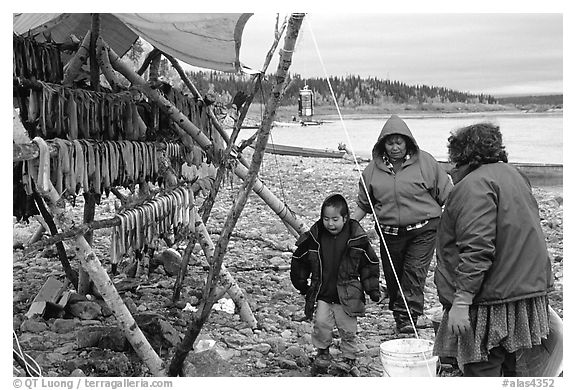 Inupiaq Eskimo family with stand of dried fish, Ambler. North Western Alaska, USA