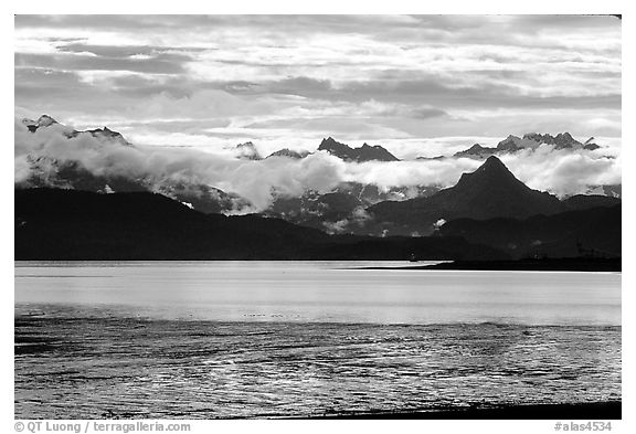 Low clouds haning over Kenai Mountains across Katchemak Bay. Homer, Alaska, USA (black and white)