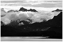 Mountains rising above bay with low clouds. Homer, Alaska, USA (black and white)