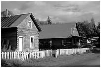 White picket fence and wooden houses. Hope,  Alaska, USA ( black and white)