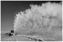 Snow plow truck with cloud of snow. Alaska, USA (black and white)