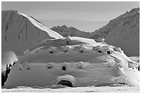Snow-covered dome-shaped building. Alaska, USA ( black and white)