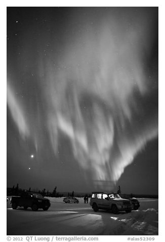 Northern Lights dance above snowy parking lot. Alaska, USA