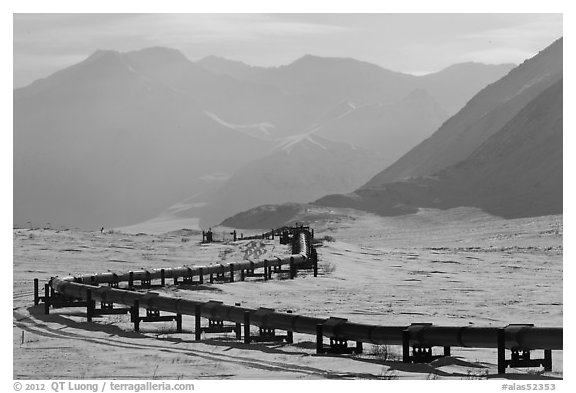 Alaska Pipeline snaking below Arctic Brooks mountains in winter. Alaska, USA (black and white)