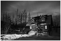 Cabin at night with Aurora Borealis. Wiseman, Alaska, USA (black and white)