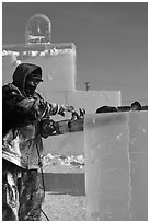 Sculptor using electric saw to carve ice. Fairbanks, Alaska, USA ( black and white)