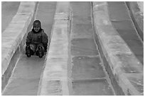 Girl on slide made of ice, George Horner Ice Park. Fairbanks, Alaska, USA (black and white)