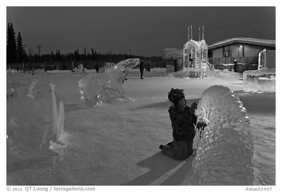 Child amongst ice sculptures at dusk. Fairbanks, Alaska, USA